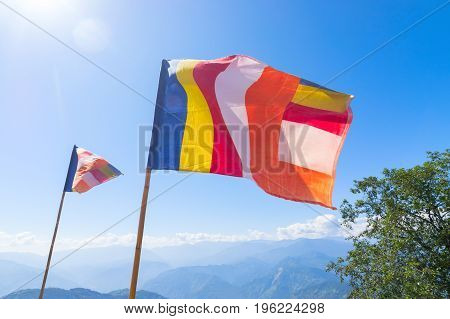 Colurful Buddhist Prayer flags are waving in strong wind under sunshine at Samdruptse huge buddhist memorial Monastery in Sikkim India.