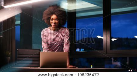 Young african american female Entrepreneur Freelancer Working Using A Laptop In night Coworking space