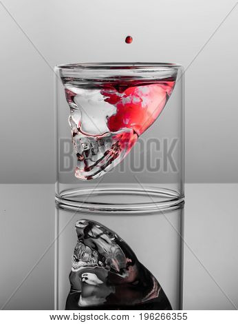 Dark thoughts. Negative with red stains in the glass skull.