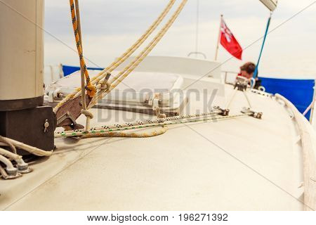 Detailed close up of down side of sail mast on boat during sea cruise. Yachting sailing objects concept.