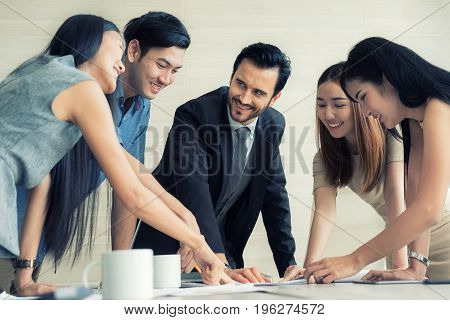 Group of multi-ethnic business partners discussing ideas in meeting room at office. Business people meeting corporate communication teamwork concept.