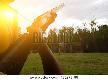Man holding gun in street. Sunflare effect