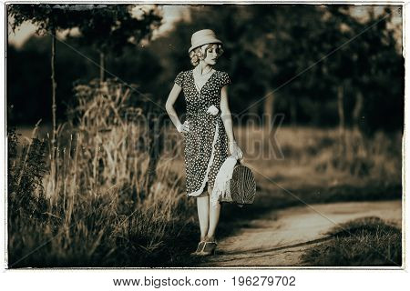 Classic Black And White Photo Of 1930S Summer Fashion Woman With Dress And Straw Hat Standing With H