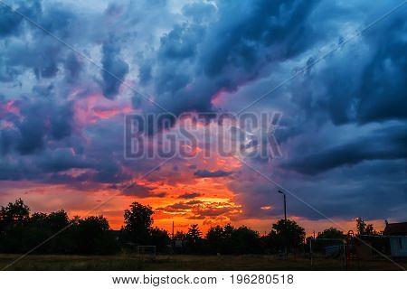 Sunset over the village after summer rain. It looks like an explosion of a nuclear bomb.