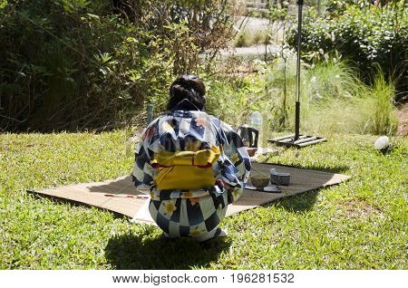 Japanese Women Making Sado Chanoyu Or Japanese Tea Ceremony, Also Called The Way Of Tea At Outdoor