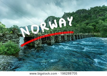 Tourist woman standing on stone slab bridge Terland Klopp in Norway Dalane region.