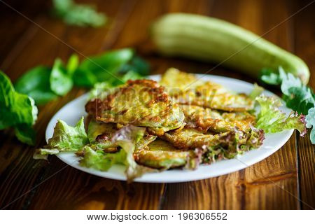 Zucchini fried in batter on a wooden table
