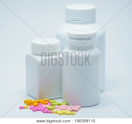 Capsule pills with bottles on white background