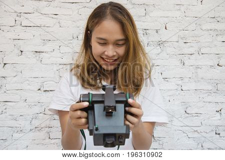 Young asian woman smiling with camera, she looked at the photo in the camera