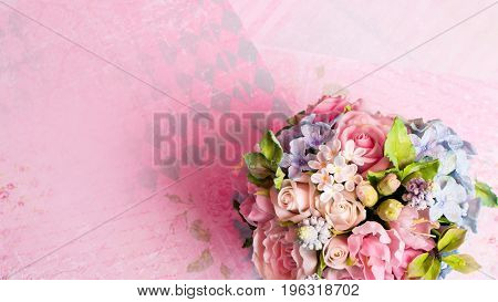 a bouquet of flowers on a pink background in style shabby chic.
