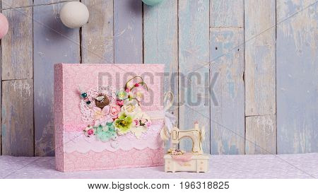 a photo album in the style of shabby chic on a blue background.