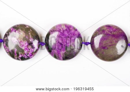 The Violet bracelet beads. The Semiprecious stones of Siberia. Charoit. White background. Isolated.