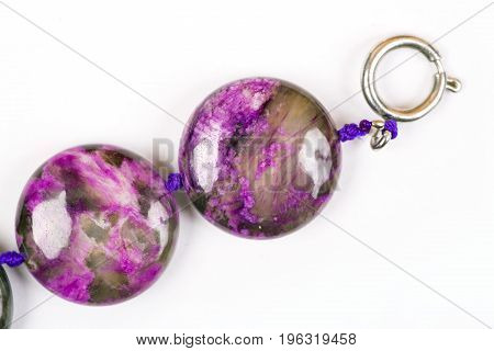 The Violet bracelet beads. The Semiprecious stones of Siberia. Charoit. White background. Isolated.