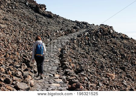 Beautiful view of the girl hiking to the Teide volcano
