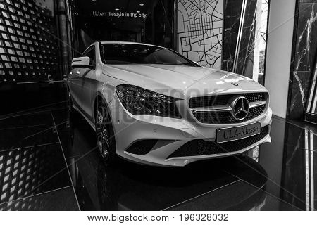 BERLIN - JANUARY 24 2015: Showroom. Compact executive car Mercedes-Benz CLA200. Black and white. Produced since 2013.