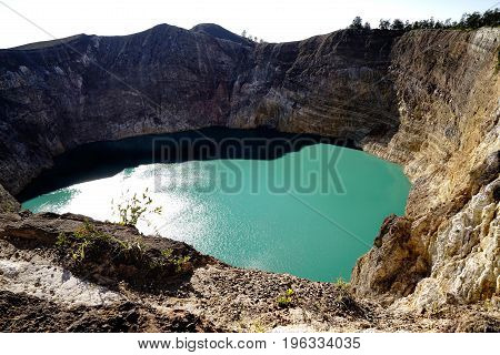 High Panoramic View Of The Green Turquoise Colored Lake In The Kelimutu Volcano During The Morning A