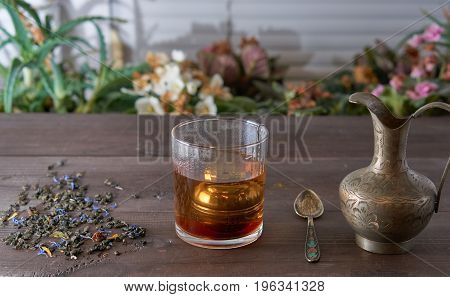 Cup Of Tea With Jug On Kitchen Desk