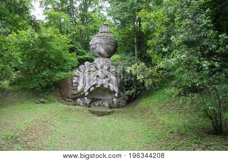 Bomarzo, Italy - May 20, 2013. View of sculpture amidst the vegetation in the Park of Bomarzo, created to surprise the visitor with surrealistic works in stone. Lazio region. Retouched photo