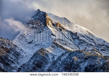 Fresh snow on a sunlit mountain peak in the Canadian Rockies British Columbia Canada after a snow storm.