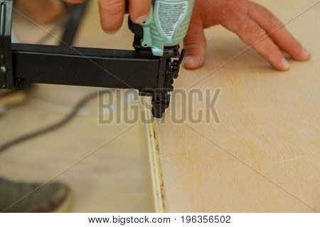 Gauge Finish Nailer man nailed slats custom house building contractor up a wall section for luxury custom house