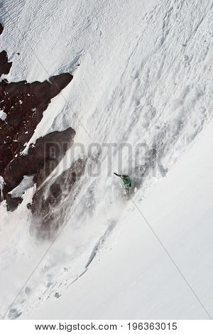 Snowboard freeride. Freerider falling from a in avalanche