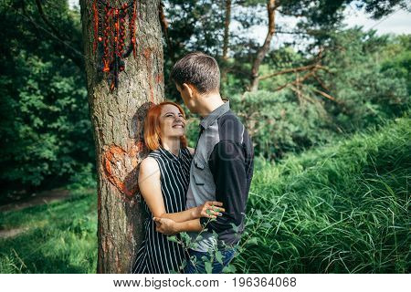 Love couple kissing under a tree, dreamcatcher on the tree