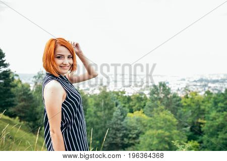 pretty gignger girl portrait on the peak of the hill