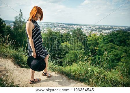 pretty gignger girl portrait on the peak of the hill