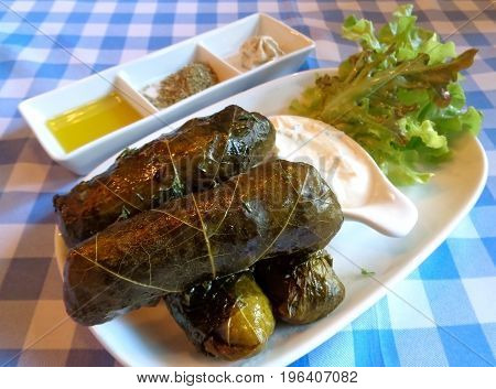 Traditional Greek and Mediterranean Food Dolmades, Grape Leaves Stuffed with Rice and Herbs with Yogurt Dip
