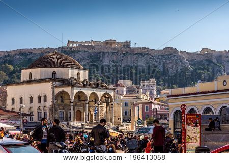 Athens, Greece - March 4 2017: Busy afternoon at monastiraki area with Acropolis and the Parthenon in the background.