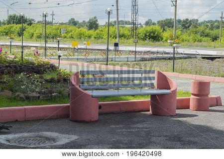 Park with a bench for waiting trains