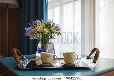Hot coffee in the morning in the hotel in front of the window
