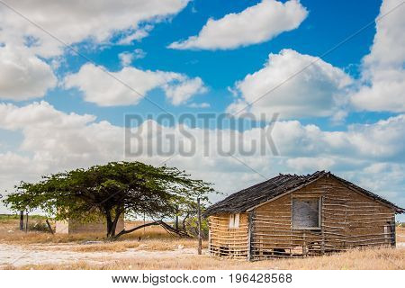 Traditional adobe house on the desert under blue sky