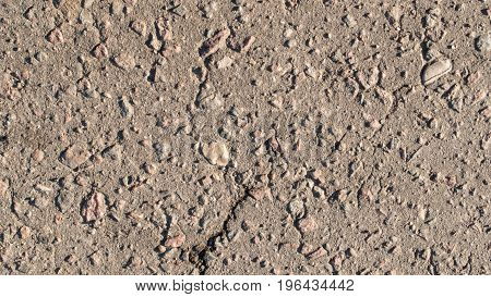 The texture of asphalt with large stones.