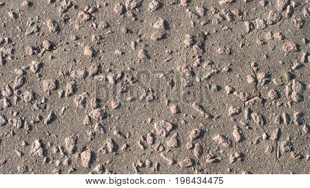 The texture of asphalt with large stones.