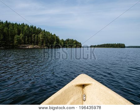 In a boat on a Finnish lake surrounded by green forests