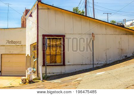 Boarded Up Windows On Corner Antique Store Out Of Business
