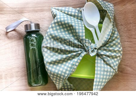 Healthy lunch box wrapped by Japanese wrapping cloth Furoshiki style with green vegetables and fruits juice bottle Homemade Healthy lunch box set for diet and healthcare concept