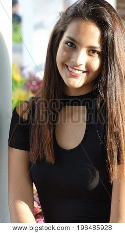 Girl Teenager With Long Hair and Wearing a Black Dress