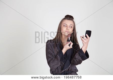 Girl In Coat Makes Brush Makeup Looks In The Mirror