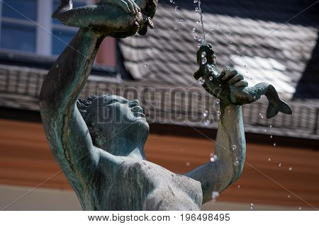 MAINZ, GERMANY - May 28: The fish fountain created by Elsa Montag in the Gau Street at the Court of Ostein with a mermaid sculpture on May 28 2017 in Mainz.