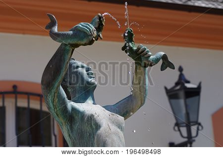 MAINZ, GERMANY - May 28: The fish fountain created by Elsa Montag in the Gau Street at the Court of Ostein with a mermaid sculpture on May 28 2017 in Mainz.