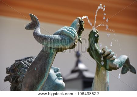 MAINZ, GERMANY - May 28: The fish fountain created by Elsa Montag in the Gau Street at the Court of Ostein with a mermaid sculpture on May 28 2017 in Mainz.
