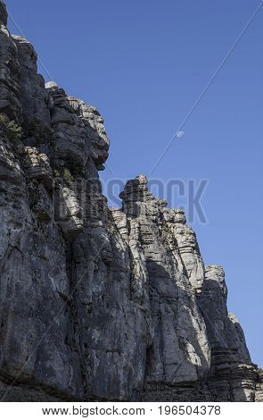 Karstic rock formations with moon at Torcal de Antequera National Park Malaga Spain