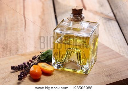 Homemade orange liqueur on a wooden table. Selective focus