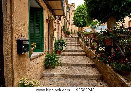 Old European street decorated with fresh flowers city of Valldemossa. Palma de Mallorca. Spain