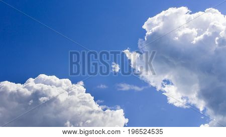 a big and fluffy cumulonimbus cloud in the blue sky.