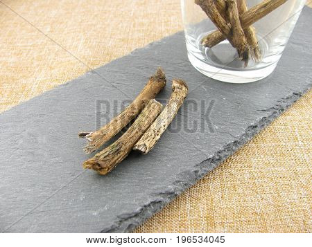 Dried liquorice pieces on a slate plate