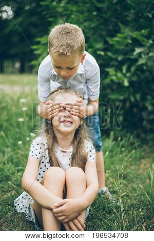 kids playing in the park, guess who, closing each other eye, siter and brother