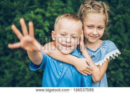 Grandmother playing in the park with grandchildren, siter with brother